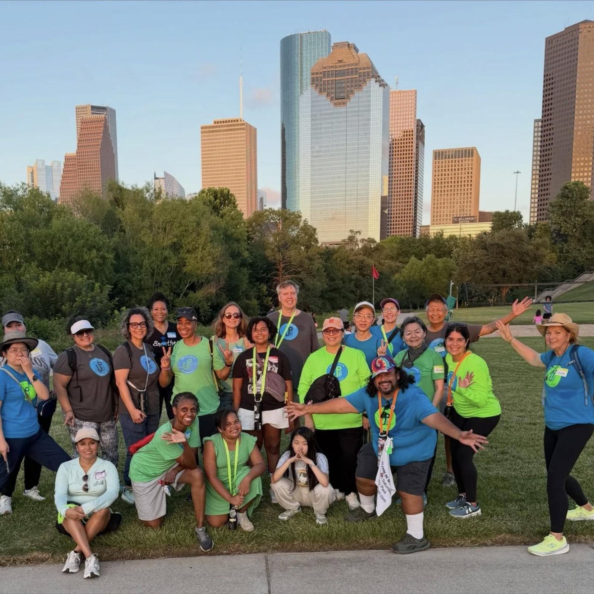 An Urban Paths wellness walk group in front of the downtown Houston skyline