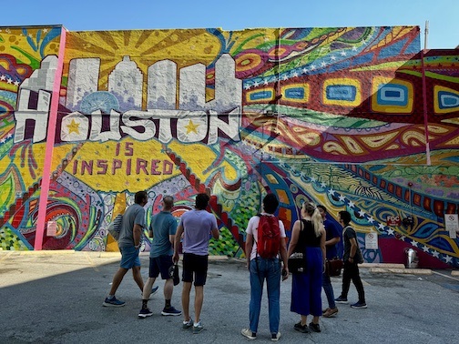 Walkers standing in front of Houston is Inspired mural