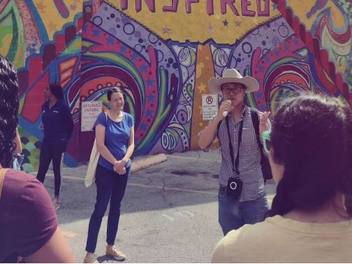 Walkers standing in front of Houston is Inspired mural