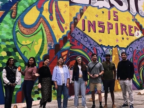 Walkers standing in front of Houston is Inspired mural